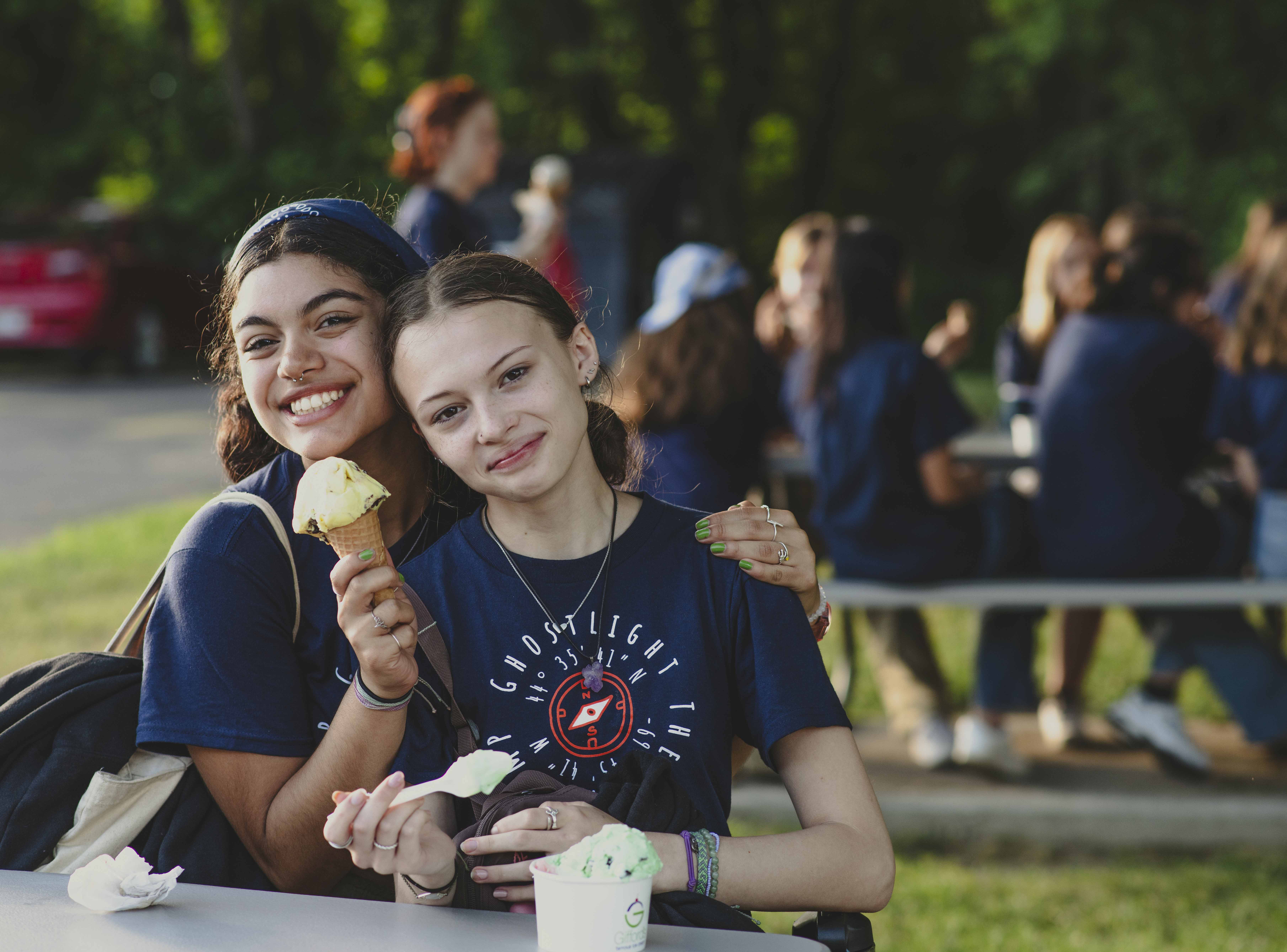 Two campers enjoy some ice cream